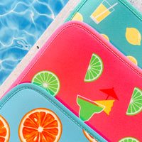 Colorful Citrus Delight Collection poolside mats by Emerson West by the poolside, hinting at a vibrant summer day.