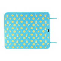 A vibrant blue poolside mat adorned with a playful pattern of lemons and tall glasses of lemonade, offering a zest of summer vibes while protecting your swimsuit and skin from hot surfaces. - Emerson West Lemonade Poolside Seating Mat