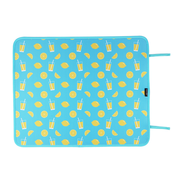 A vibrant blue poolside mat adorned with a playful pattern of lemons and tall glasses of lemonade, offering a zest of summer vibes while protecting your swimsuit and skin from hot surfaces. - Emerson West Lemonade Poolside Seating Mat